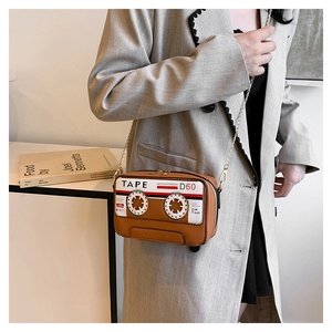 Detailed view of creative vintage tape shape crossbody bag with gold chain strap for women