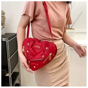 Detail of red heart-shaped jacket bag with zipper moto style and gold logo