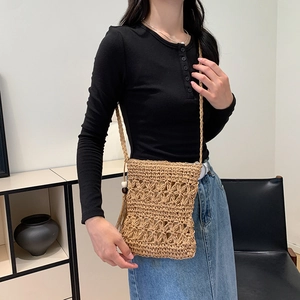 Bohemian woven straw crossbody bag with floral pattern and tassels for beach vacation