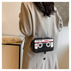 Detailed view of the vintage cassette tape crossbody bag with gold chain and retro print