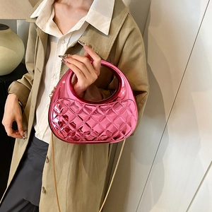 Metallic pink semi-circle crossbody bag with quilted pattern and metal handle