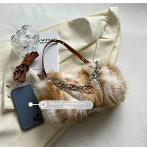 Brown and white faux fur shoulder bag size comparison with an iPhone mobile phone