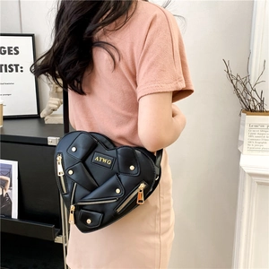 Creative black heart-shaped crossbody bag featuring motorcycle jacket design and gold zippers