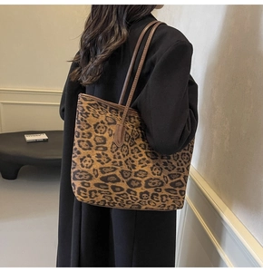 Detailed view of the large leopard print tote bag with brown leather shoulder straps