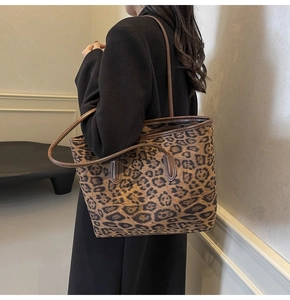 Chic leopard print tote bag styled as a shoulder bag on a model in a warm interior