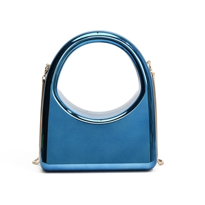Sleek metallic blue hard shell box bag with large ring handle and gold chain strap