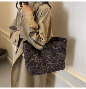 Detail of large leopard print tote bag styled with a classic khaki autumn trench coat