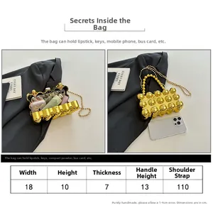 Detailed size chart for golden spherical evening clutch bag with chain strap