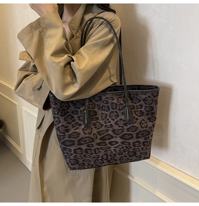 Large leopard print tote bag styled with a khaki trench coat for a chic autumn look
