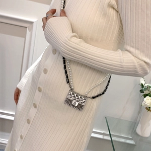Mini silver quilted crossbody bag with pearl strap and leather-metal chain necklace