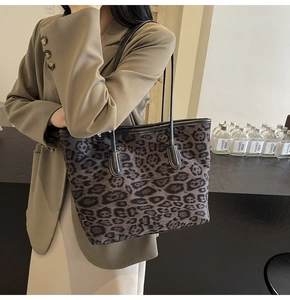 Detailed view of the dark grey leopard print tote bag with black leather handles