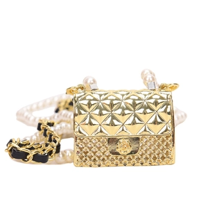 Golden mini quilted bag with rose clasp and pearl chain strap on white background