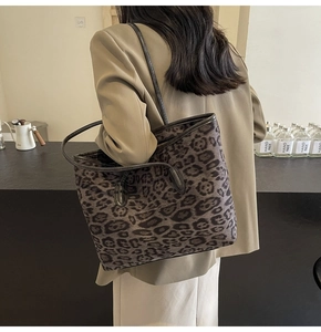 Large leopard print tote bag styled with a khaki blazer for an elegant autumn look