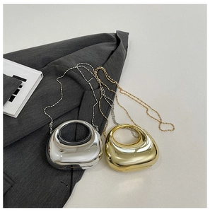 Detail of metallic acrylic mini clutch bags in gold and silver with chain straps