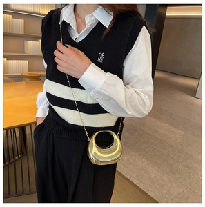 Chic gold metallic crescent bag with bead chain styled with striped knitwear fashion