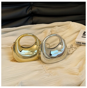 Detailed view of mini metallic chain bags in gold and silver mirror finish