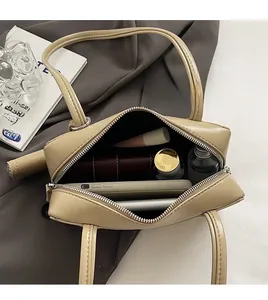 Spacious interior of beige Boston bag showing organized daily items and side pockets