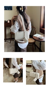 Detail of cream bowling shoulder bag with small coin purse and dual strap design