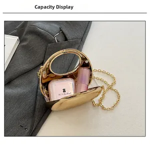 Detailed interior of gold round evening clutch showing capacity for lipstick and makeup