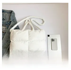 White quilted puffer tote bag interior view showcasing large capacity and soft padded fabric