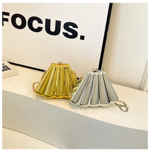 Detailed view of pleated metallic gold and silver evening clutch bags with chain straps