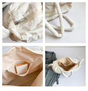 Détail du sac matelassé avec fermeture éclair argentée et intérieur spacieux