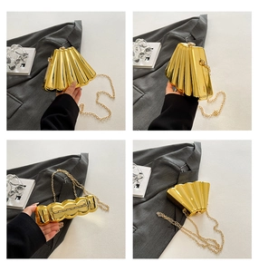 Detailed view of the gold fan-shaped evening clutch with textured metallic finish and chain