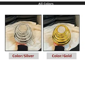 Detail showing gold and silver evening bags with spiral metal texture and chain straps