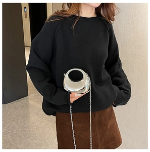Chic silver crescent mini bag with chain handle shown with a stylish autumn outfit
