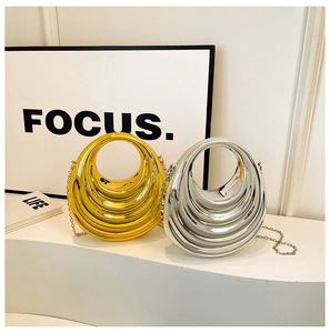 Close-up of metallic crescent evening bags with wave texture and chain straps