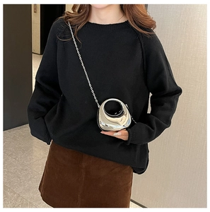 Mini silver crescent chain bag with mirror finish shown on a model for scale and style