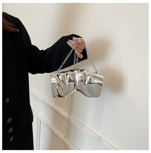 Detail of silver metallic box bag with irregular pleated texture and chain strap