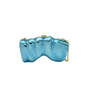 Macro shot of electroplated light blue evening bag with gold clasp and chain strap