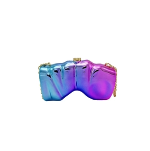 Detailed macro view of iridescent blue-purple gradient metal hard shell evening clutch bag