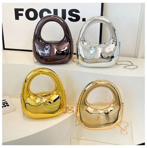 Chic metallic dumpling bags in four colors arranged on white display stands with chain straps