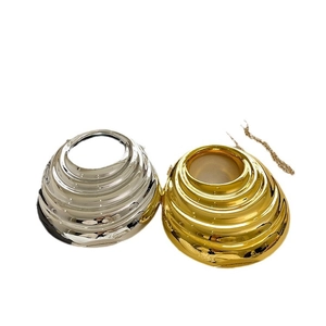 Chic dome-shaped evening bag in gold and silver finish with concentric spiral texture