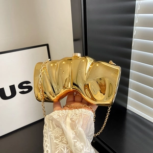 Modern gold metallic wing-shaped clutch bag with wavy texture and fine chain strap