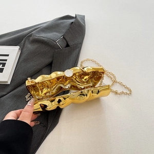 Metallic gold evening clutch bag with wavy texture and gold chain strap in open view