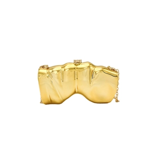 Artistic golden wing clutch bag with sleek metal texture and detachable chain strap