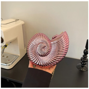 Pink conch shell acrylic clutch bag with golden chain strap for elegant dinner parties