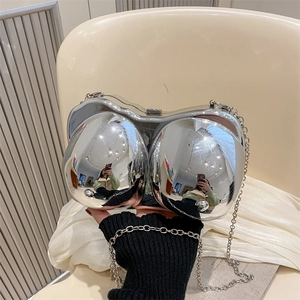 Quirky silver bra-shaped evening clutch bag with metallic mirror finish and chain strap