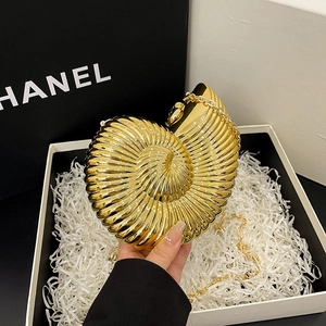 Elegant gold nautilus shell evening clutch bag with metallic chain and mirror finish