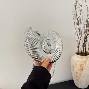 Silver conch-shaped acrylic evening clutch bag with delicate chain strap for women