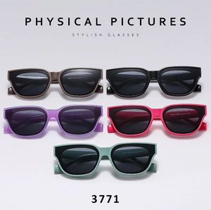 Flat lay of stylish square sunglasses in various colors including pink, green, and black
