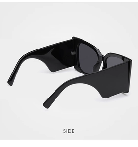 Side view of black thick-frame sunglasses featuring wide geometric-cut temples