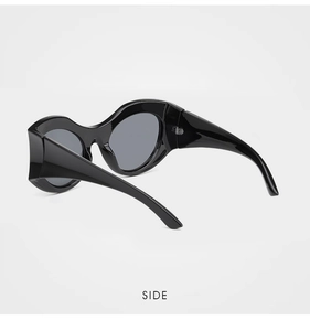 Side view of avant-garde wavy thick frame sunglasses with deep grey lenses and glossy finish