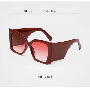Close-up of wine red oversized sunglasses with red gradient lenses from a 45-degree side view