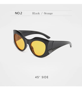 Detail view of bold black wavy frame sunglasses with vibrant orange lenses at 45 degree angle