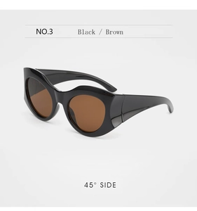 Detail view of bold oversized sunglasses with black thick frame and brown lenses