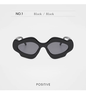 Vue frontale de lunettes de soleil géométriques noires à vagues avec verres gris foncé